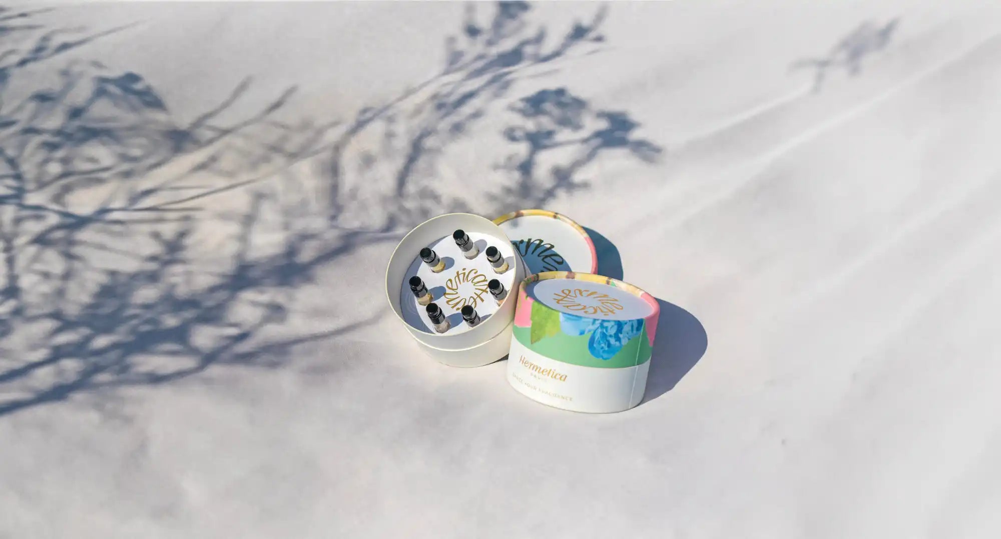 Metal herb grinder with colorful tie-dye pattern design.