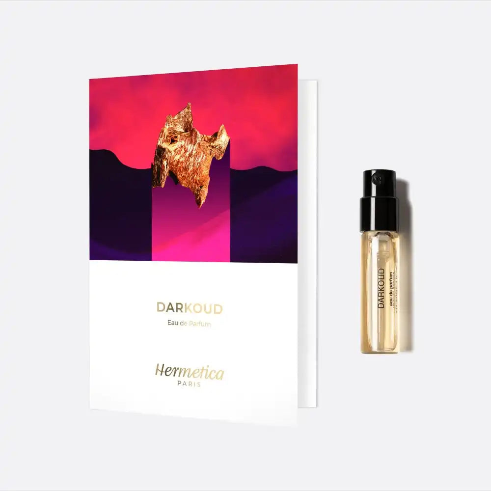 Perfume sample vial next to a product card with red and purple artwork.